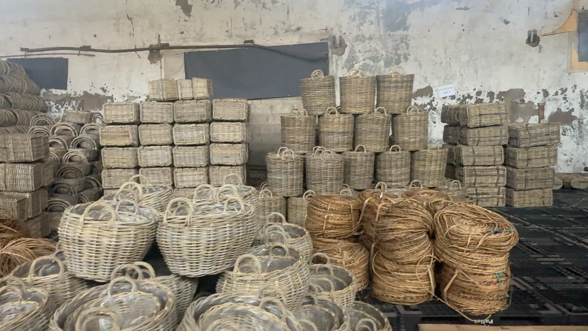 Finished rattan baskets arranged in a storage area